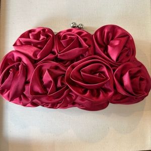 Red rosette satin clutch by Lulu Townsend.
